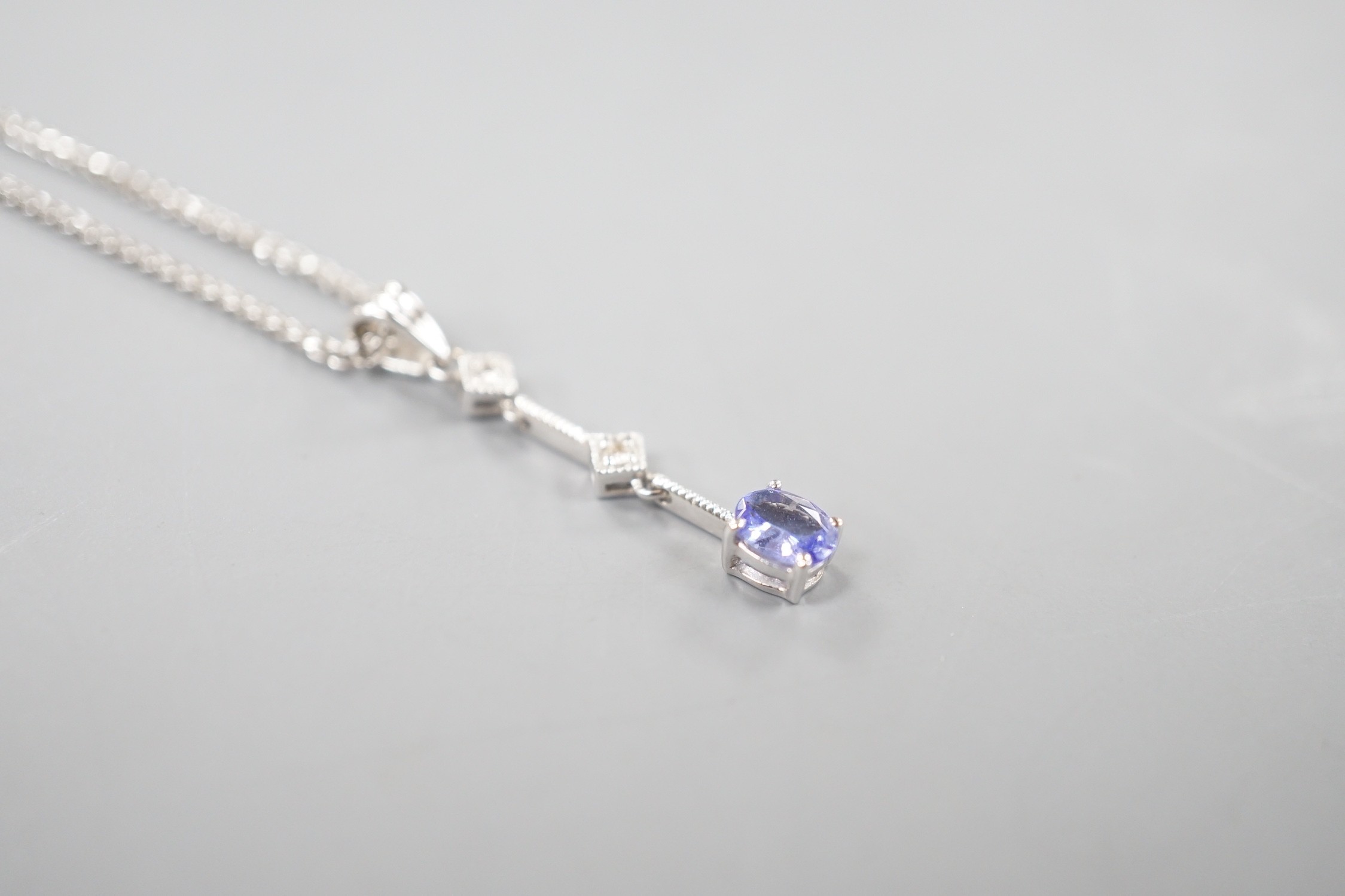 A modern Italian 705 white metal tanzanite and diamond set three stone pendant necklace, 48cm, gross weight 4 grams.